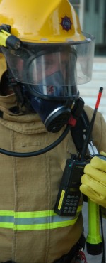 A breathing apparatus set user checking the contents of the cylinder with the gauge